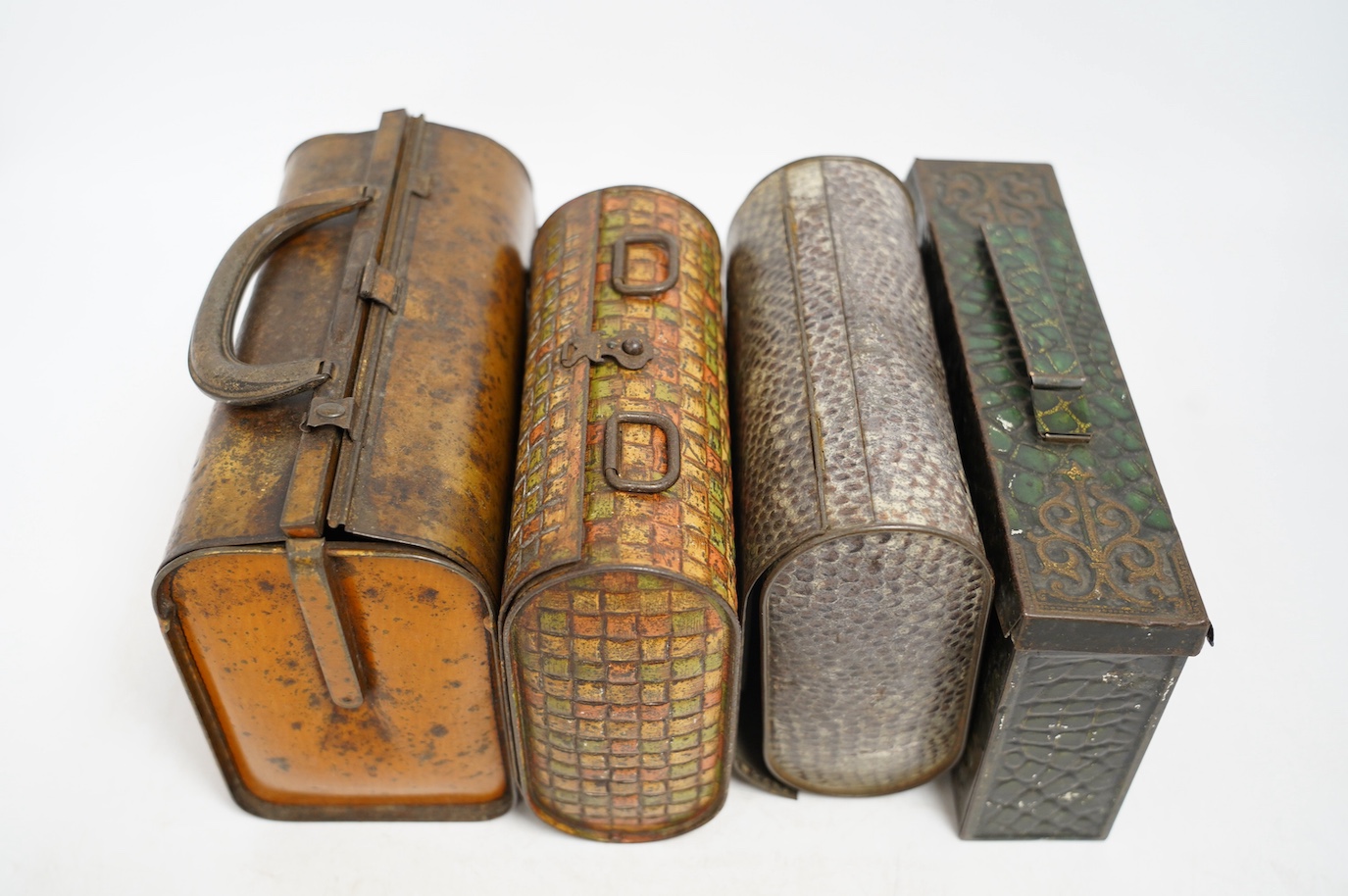 Four biscuit tins: an early 20th century Huntley & Palmers novelty biscuit tin, modelled as a Gladstone bag, 20cm wide, 16cm high, two other Huntley & Palmers tins and a Peek Frean novelty biscuit tin. Condition - fair